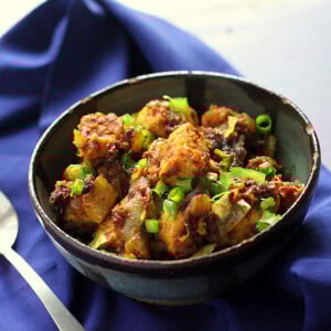 Keralan Tempeh Chili Roast in a black bowl on a blue cloth