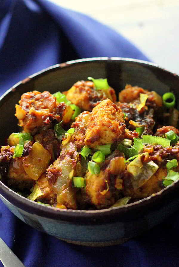 Keralan Tempeh Chili Roast in a black bowl on a blue cloth