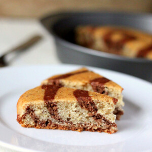 two slices of marble/zebra cake on a white plate