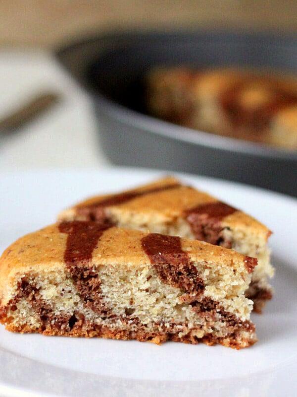 two slices of marble/zebra cake on a white plate