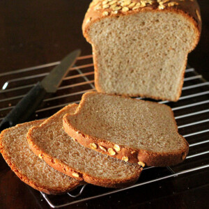 A loaf of everyday sandwich bread cut into slices on a cooling rack