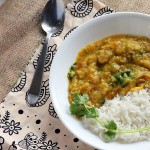 A bowl of toor daal and rice on patterned fabric