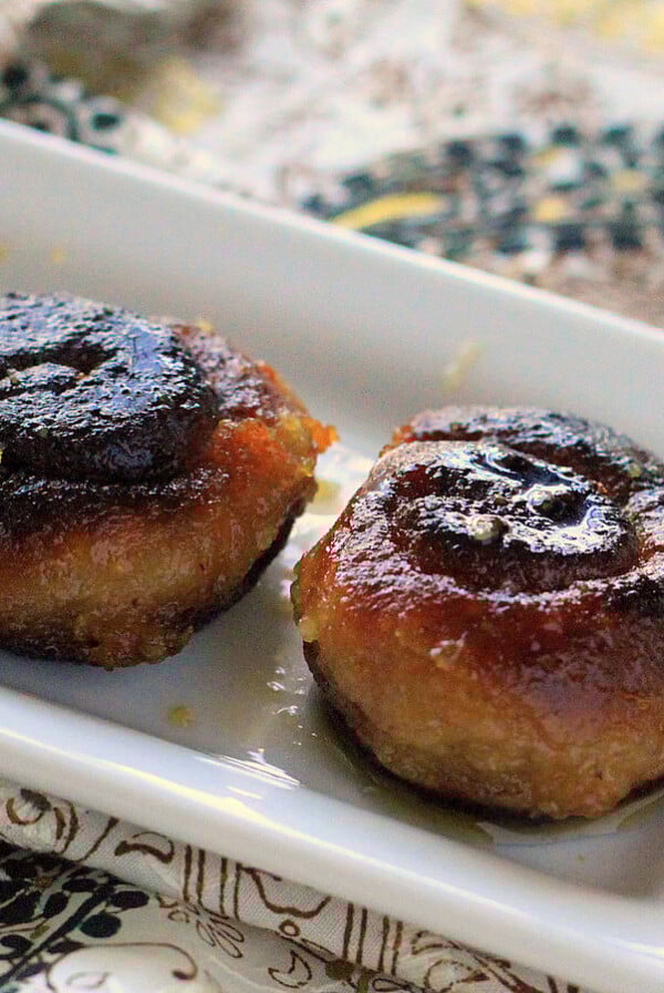 Two kala jamuns on a white plate