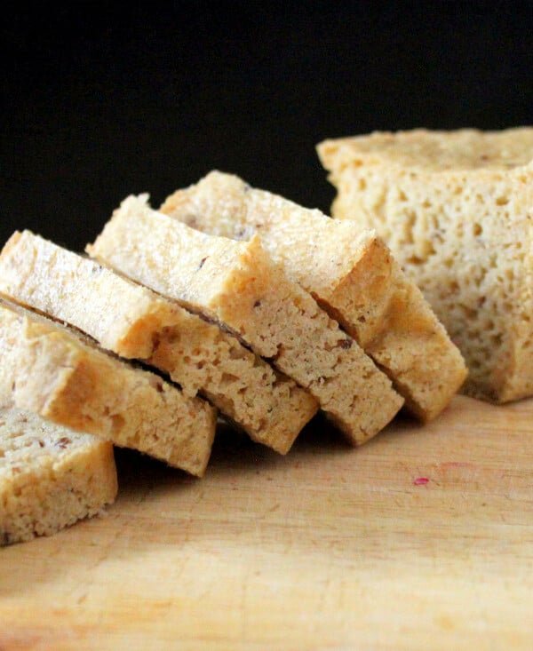 Slices of gluten free sourdough bread on a wooden chopping board