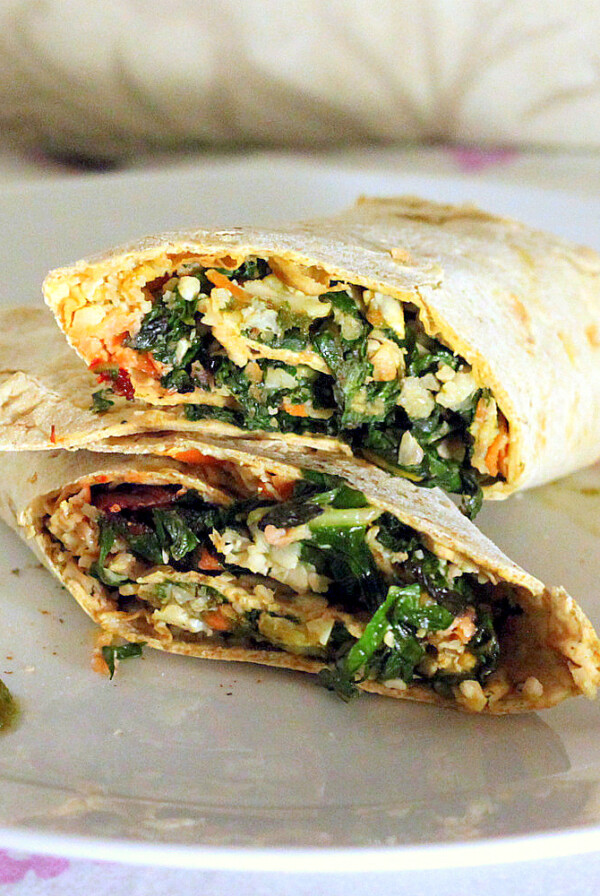 A cauliflower wrap cut in half and stacked