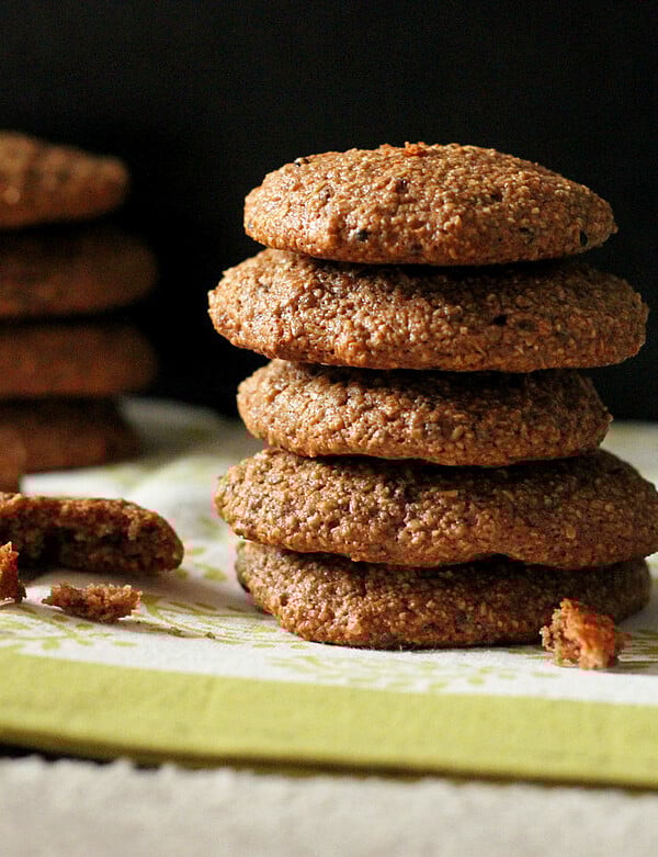 A stack of chocolate quinoa oat cookies on a dark background