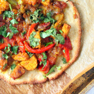Top down shot of a gluten free pizza with colorful toppings