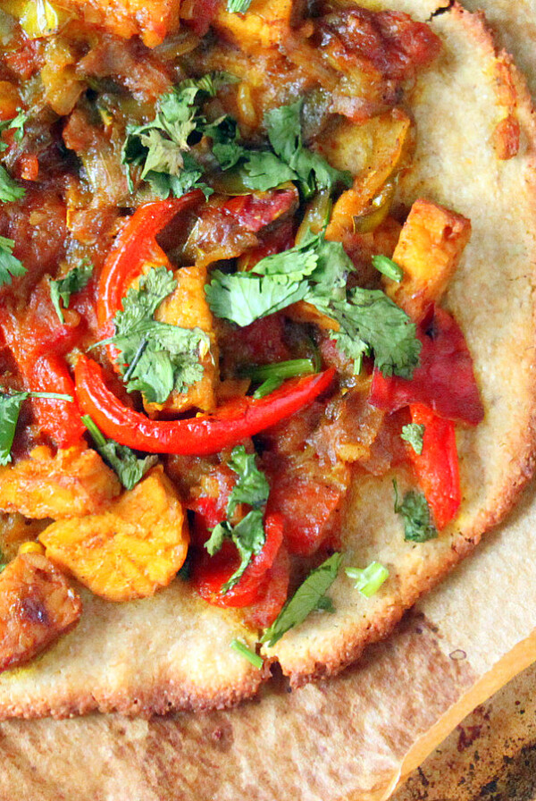 Top down shot of a gluten free pizza with colorful toppings