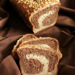 Vanilla wheat bread cut in half on a fabric background