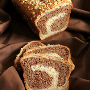 Vanilla wheat bread cut in half on a fabric background