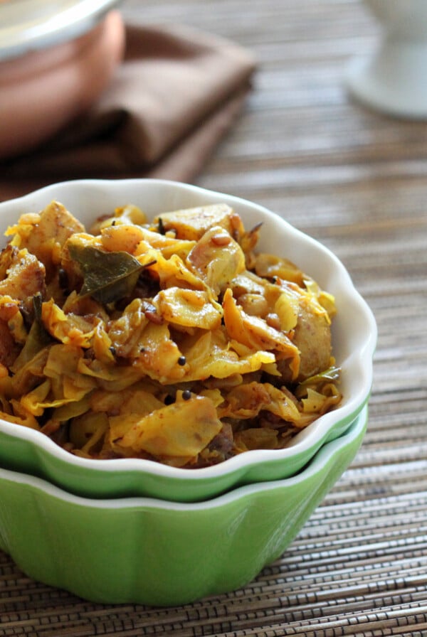 Spiced cabbage and potato in a small green bowl