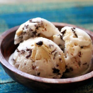 Three scoops of ice cream in a wooden bowl