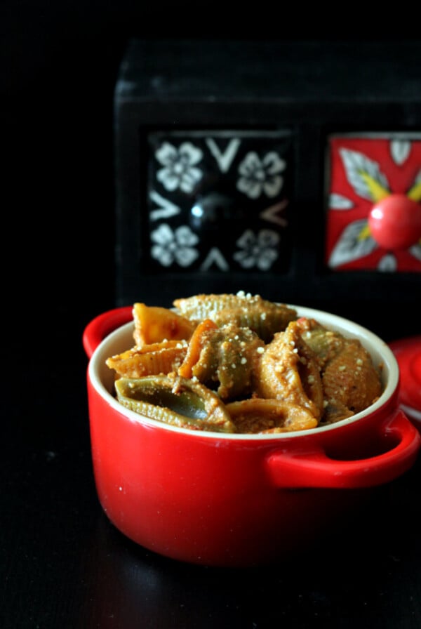 Vegan Chipotle mac and cheese in a red serving dish on a dark background