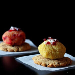 Halwa balls on crackers, served on white plates