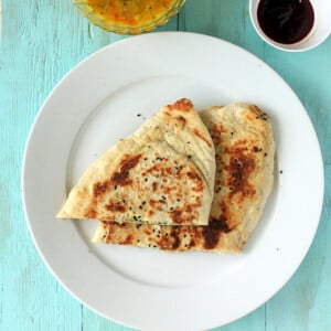 Slices of vegan naam bread on a white plate