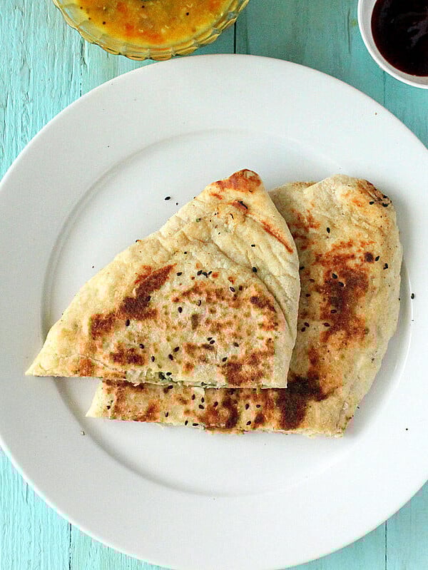 Slices of vegan naam bread on a white plate