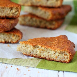 Triangles of banana quick bread on a white wooden background