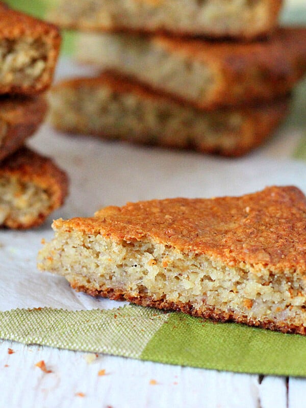 Triangles of banana quick bread on a white wooden background