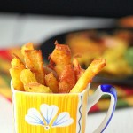 Apple fritters served in a yellow and blue mug