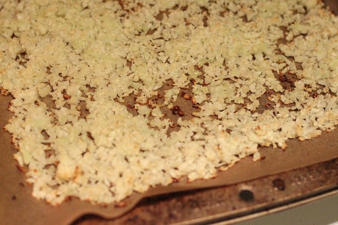 baked grated cauliflower on parchment paper
