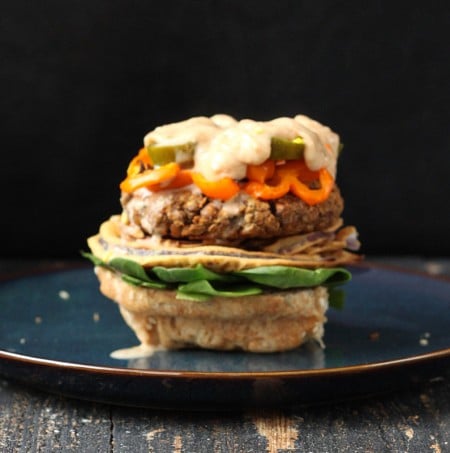 loaded vegan lentil burger without the bun top on a blue plate