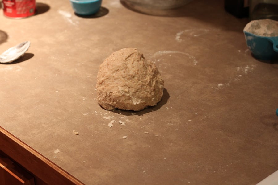 vegan cinnamon rolls  cinnamon rolls dough shaped into a ball on a kitchen counter ready to be rolled out