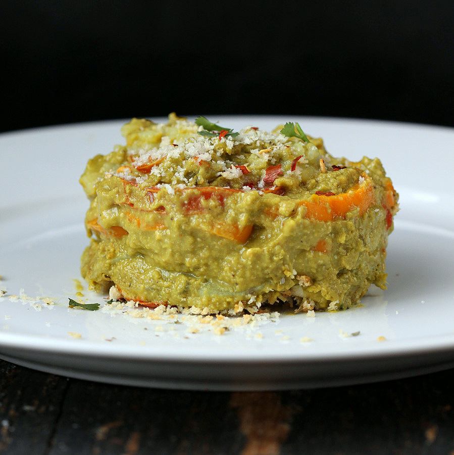 alfredo bake side view of vegan sweet potato spinach alfredo bake on a white plate