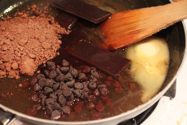 salted caramel brownies chocolate chips, chocolate and cocoa powder being added combined to make vegan brownies
