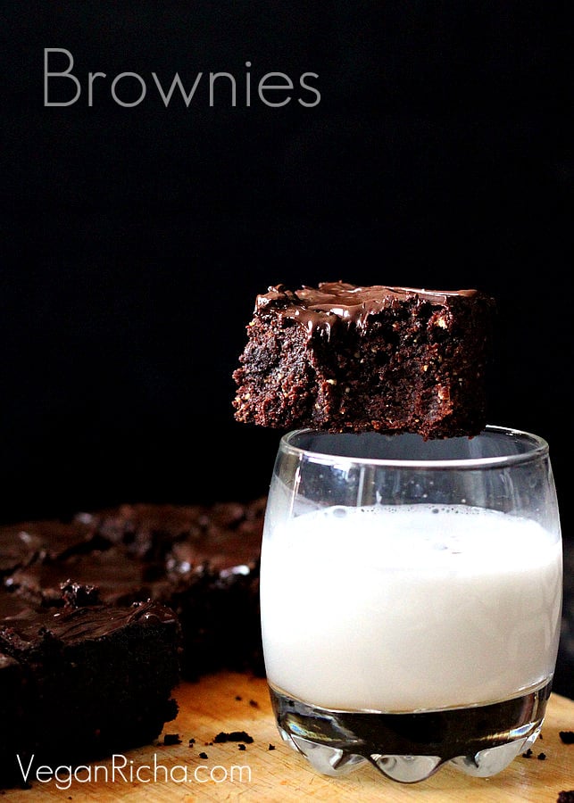 salted caramel brownies vegan triple chocolate salted caramel brownie sitting on the rim of a milk glass