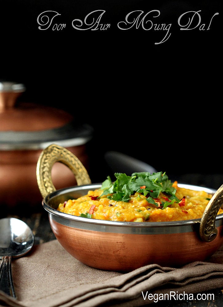 mung dal side view of a bowl with vegan Indian Mung Dal topped with chopped herbs and crushed red pepper