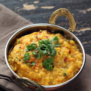 vegan mung dal in a sliver Indian serving bowl