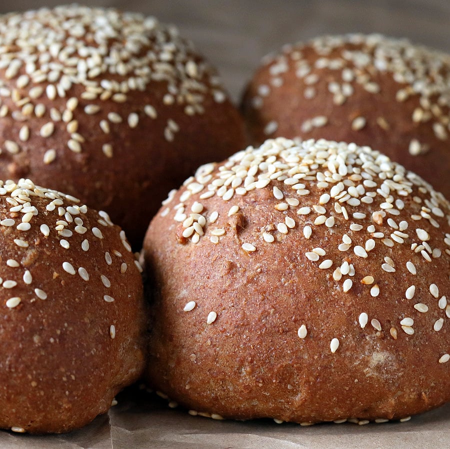 vegan burger buns  side view close-up of Rye Almond Flour Vegan Burger buns sprinkled with sesame seeds