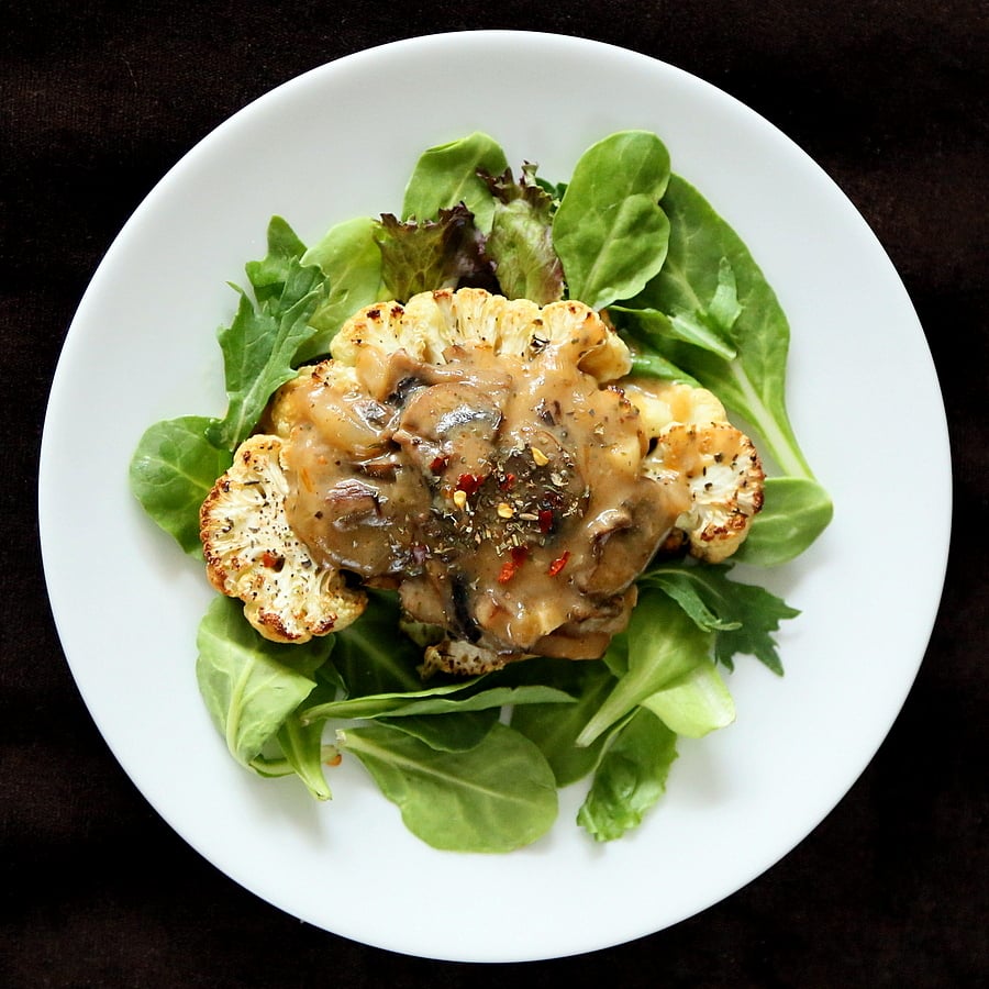 Cauliflower Steaks with Mushroom Gravy. Easy Roasted Cauliflower Slices served with mushroom thyme gravy. Vegan gluten-free Festive Main for the holid | VeganRicha.com #Vegan #Glutenfree #holiday #Cauliflower