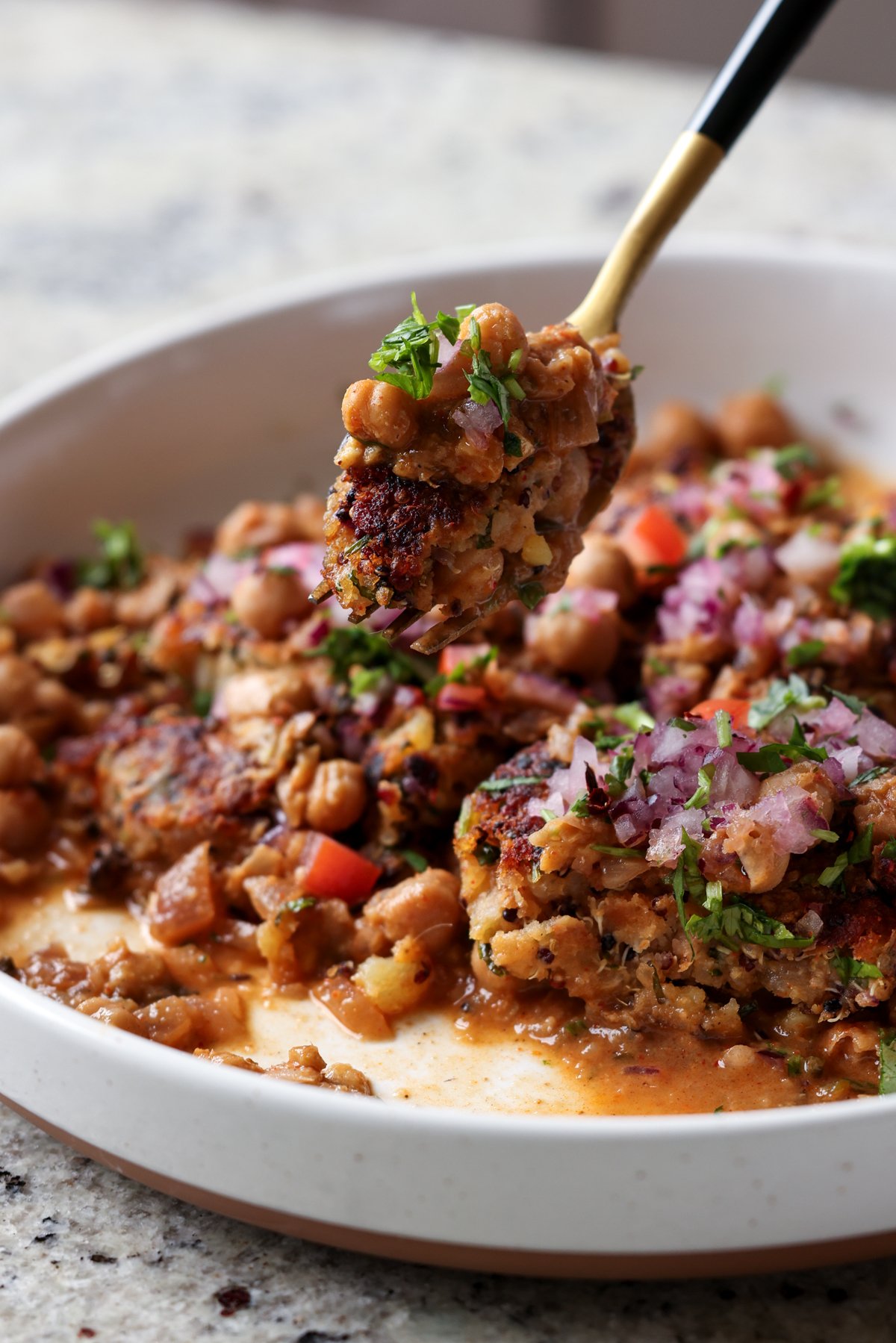 fork taking a bite of tikki chole