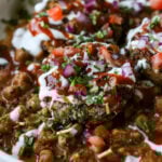 close-up of tikki chole in a bowl after adding toppings