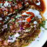 close-up of tikki chole in a bowl after adding toppings