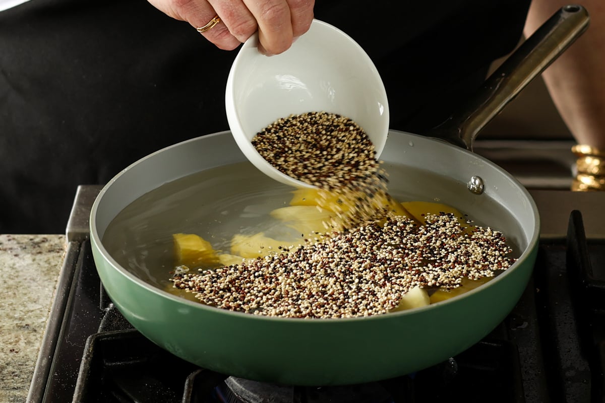 adding quinoa to the pan