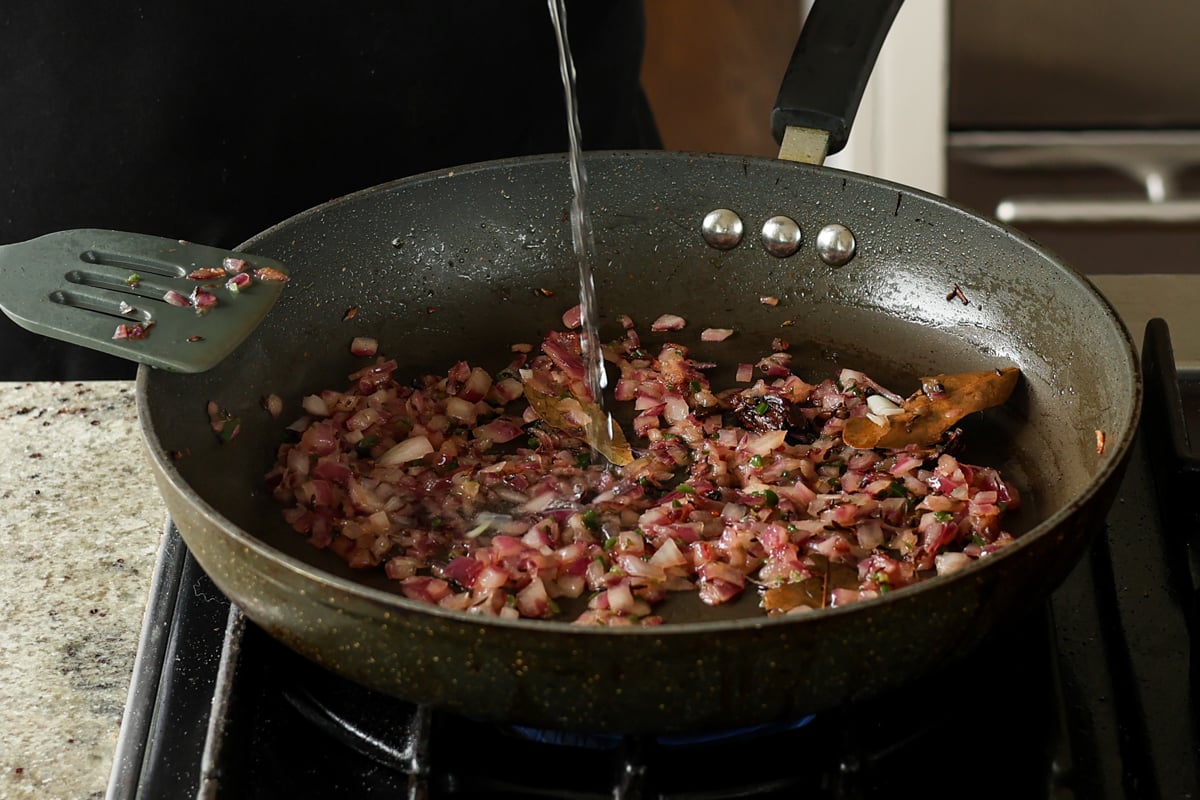 adding water to cooked onions