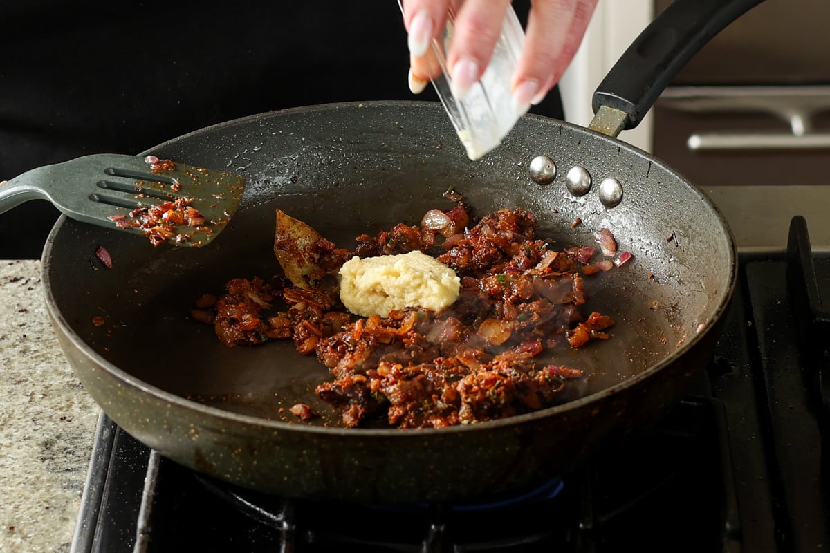 adding ginger garlic paste to the pan