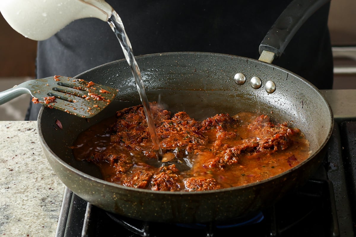 adding water to the pan