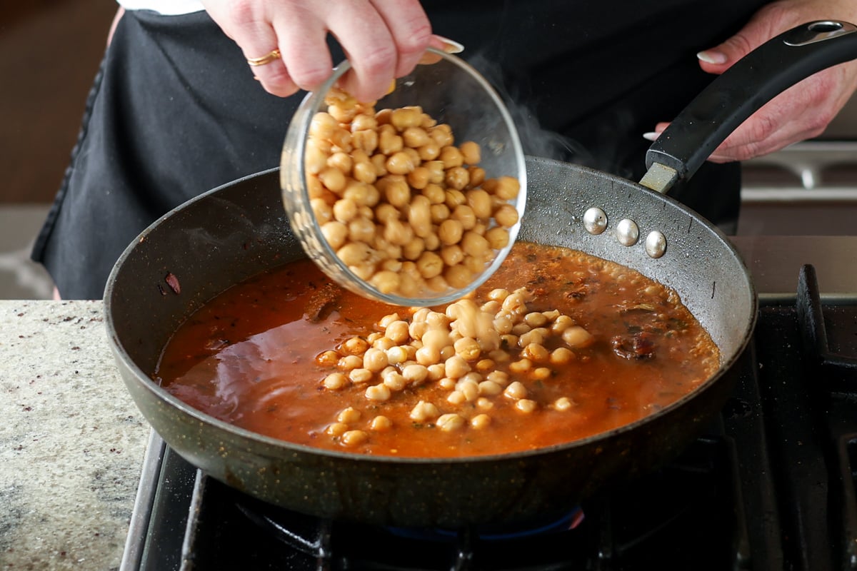 adding chickpeas to the pan