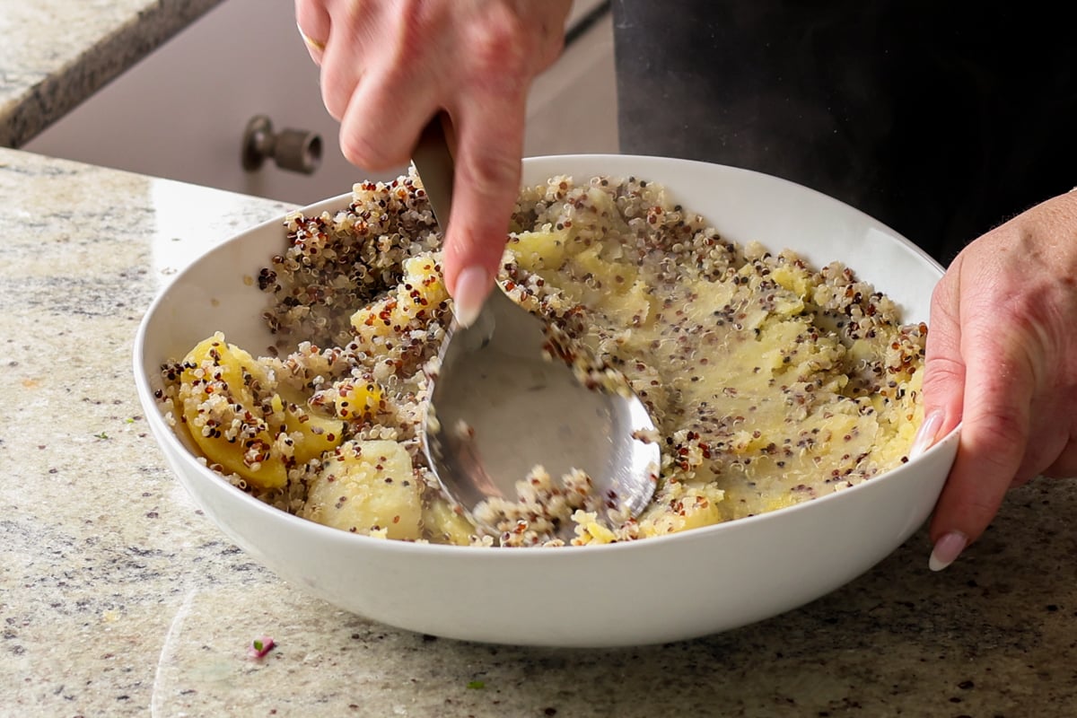 mashing the potatoes and quinoa