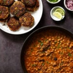 plate of tikkis next to a pan of chole