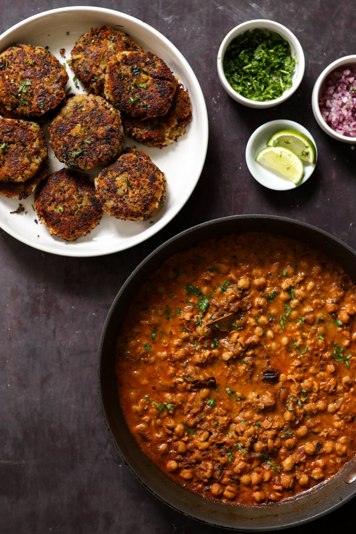 plate of tikkis next to a pan of chole