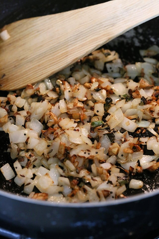 Onion and garlic getting cooked in a skillet for ourVegan Dal Makhani Recipe #veganricha #vegandalmakhani #instanpotdalmakhani