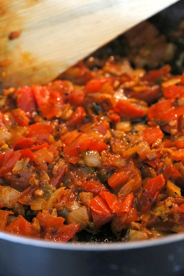 Onion, tomato getting cooked in a skillet for ourVegan Dal Makhani Recipe #veganricha #vegandalmakhani #instanpotdalmakhani
