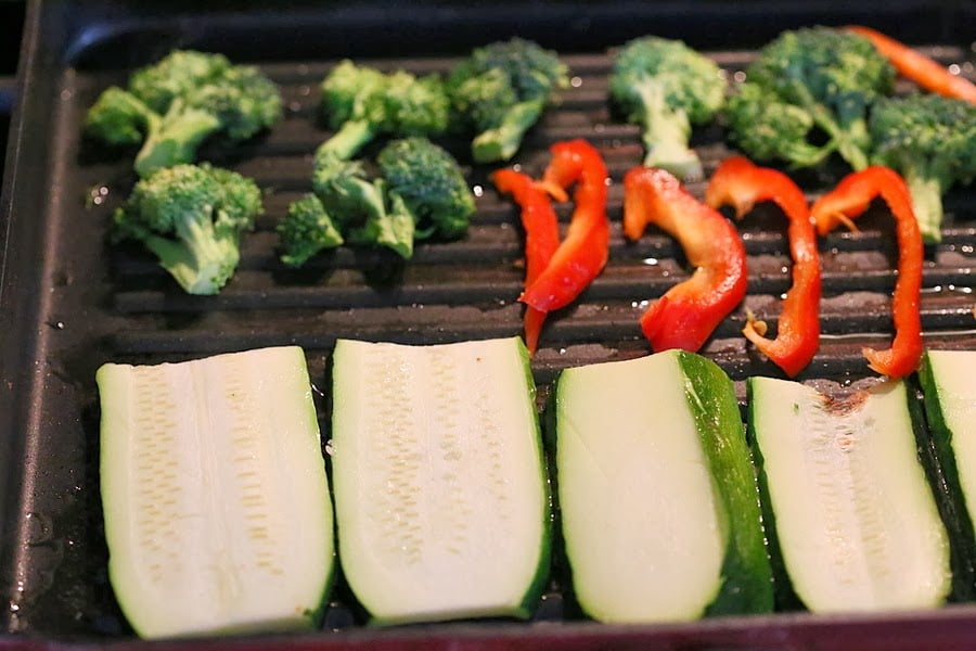 vegetable sandwich  sliced zucchini, red bell peppers and broccoli florets in a grill pan