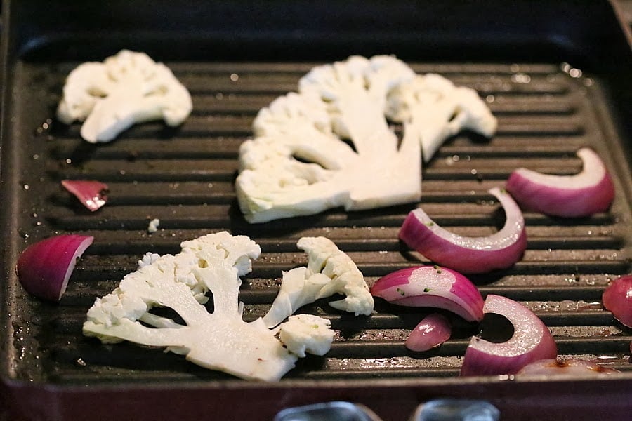 vegetable sandwich  cauliflower and onion slices roasting in a grill pan