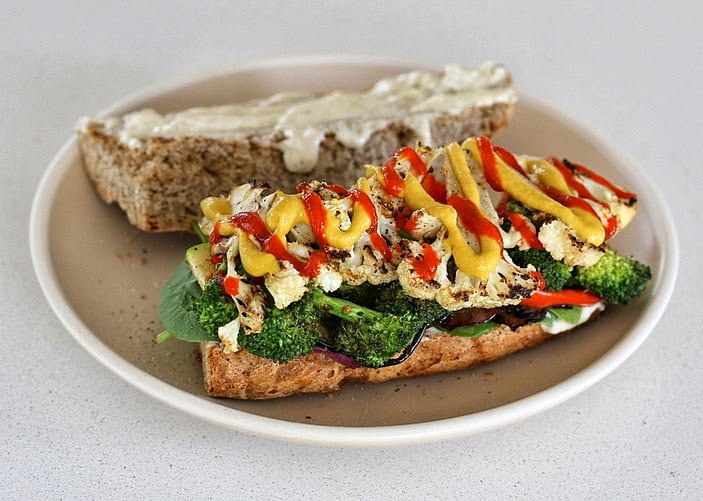 vegetable sandwich  open-faced vegan grilled vegetable sandwich with plenty of sriracha mayo and mustard drizzled on top
