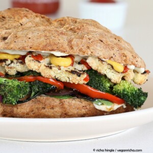 side view close-up of roasted vegan vegetable sandwich with sriracha mayo